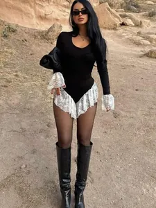Elegant black long-sleeve bodysuit with decorative white lace trim on cuffs and hem