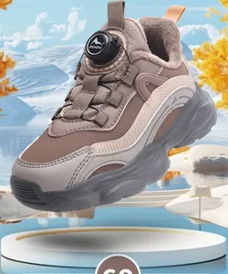 Close-up detail of girls' brown fleece-lined sneakers featuring a mechanical dial lace system