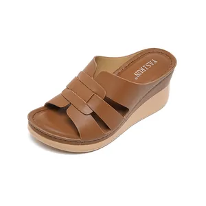 Brown faux leather wedge sandals with woven straps for women in comfortable slope heel