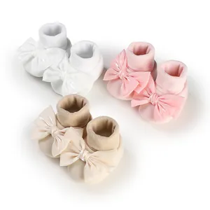 Soft baby bow anti-slip floor socks in white, pink, and beige for newborn infants