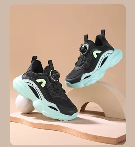 Detailed view of girls' black and mint green mesh sneakers with rotating knob closure.