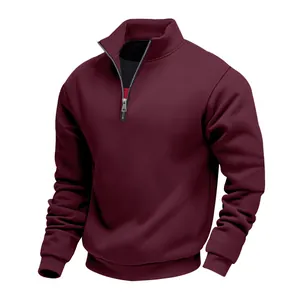 Detail of the high-quality metal zipper on a burgundy men's quarter-zip sweatshirt.