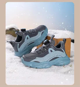 Detail of girls' grey sneakers with rotary buckle system on artificial snow