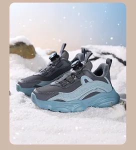 Blue girls sports sneakers featuring a rotary buckle system in snowy outdoor setting