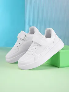 Close-up of white children's low-top sneakers with Velcro strap