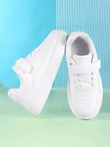 Detail view of all-white children's low-top board shoes with hook and loop closure
