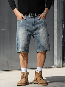 Detailed view of men's distressed carpenter denim shorts with shiny rhinestone decor