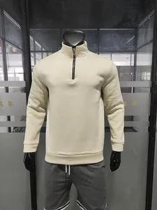 Detail view of cream heavy fleece sweatshirt featuring a stand collar and premium half-zip