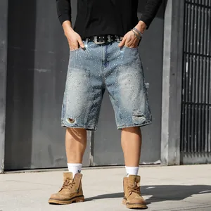 Close-up of rhinestone embellished distressed denim shorts for men in light blue wash