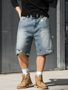 Detail view of men's distressed denim shorts with sparkling rhinestone embellishments.