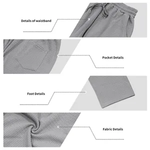 Detailansicht von Bund, Taschen und grauem Jacquard-Stoff dieser Herrenhose im Detail.