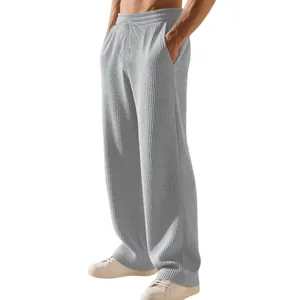 Vista dettagliata dei pantaloni della tuta a coste grigi da uomo con trama del tessuto.