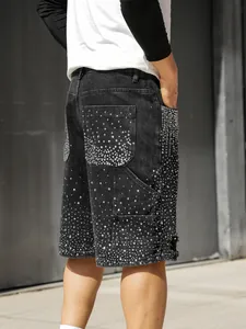 Detail of loose black denim cargo shorts for men with sparkling rhinestone studs