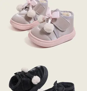 Detailed view of children's warm winter shoes with plush lining and pom-pom decor