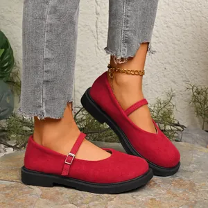 High-quality detail of red suede Mary Jane shoes with round toe and buckle strap
