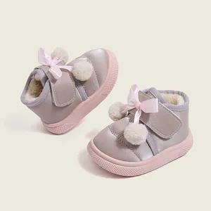Warm winter toddler boots with pink bows and white fur balls, fleece-lined.
