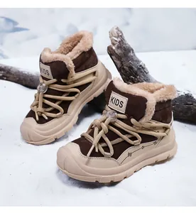 Close-up detail of children's warm brown snow boots featuring thick faux fur lining and laces
