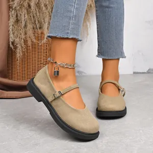 Close-up detail of khaki suede Mary Jane shoes with round toe and buckle strap.