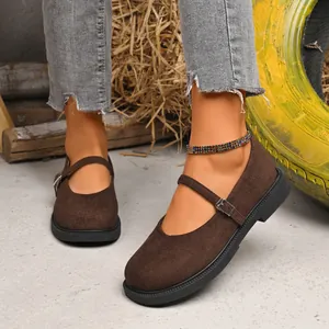 Detailed view of stylish brown suede Mary Jane shoes with a buckle strap and comfortable low heel