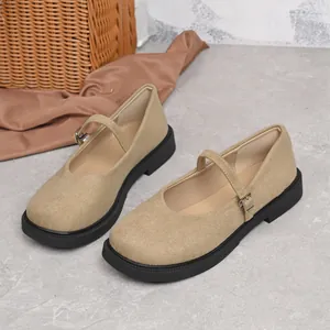 Detail view of khaki suede Mary Jane shoes with round toe and black platform sole