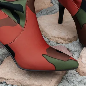 Nahaufnahme des Camouflage-Musters und des spitzen Designs stilvoller High-Heel-Stiefel