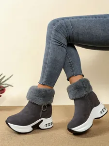 Detailed view of gray women's platform wedge snow boots with stylish faux fur trim.