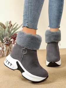 Side view detail of grey faux fur lined wedge snow boots with thick platform sole