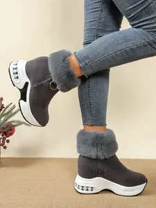 Side view of grey women's wedge snow boots with plush faux fur trim and platform sole
