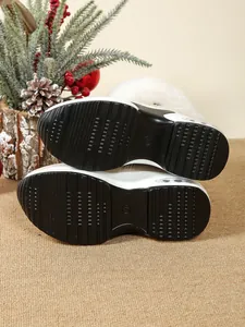 Close-up view of the textured non-slip black rubber sole on a platform snow boot