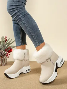 Women's beige thick-soled snow boots with white faux fur trim and side zipper