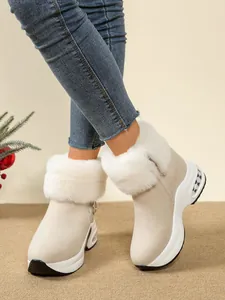 Stylish women's beige snow boots featuring a thick platform wedge sole and white faux fur