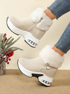 Stylish beige platform wedge snow boots with white faux fur trim and side zipper detail