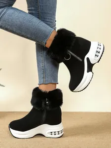 Black platform winter boots with fur trim and wedge sole, shown in a side detail view.