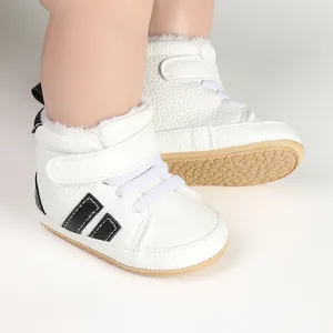 Close-up of white baby fleece-lined walker shoes with non-slip rubber soles