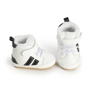 Close-up of white high-top baby shoes with warm fleece lining and black stripes