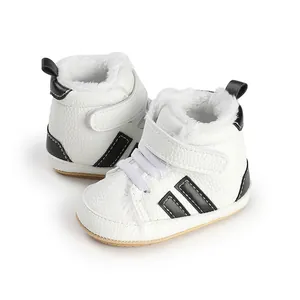 Detail view of warm white baby walking shoes with soft faux fur lining and black stripes.