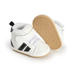 Detailed view of white plush-lined baby walking shoes with textured anti-slip sole