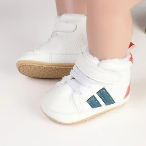 Close-up of white fleece-lined baby winter shoes with blue stripes and plush lining.