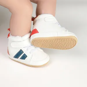 Detailed view of white infant winter walking shoes with warm lining and anti-slip sole