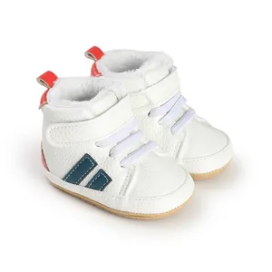 Close-up of white baby walker shoes with warm faux fur lining and blue stripes.