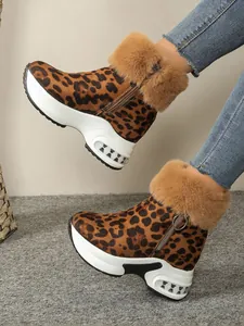 Detail view of leopard print snow boots with plush fur trim and platform sole