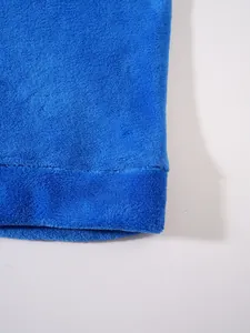 Macro detail view of blue soft fleece fabric texture on a casual men's hoodie set.