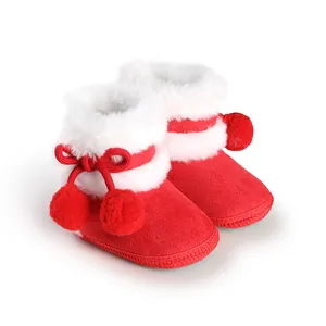 Detail view of red soft sole baby princess shoes with white faux fur trim and pompoms