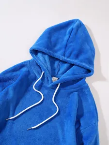 Close-up detail of a bright blue plush fleece hooded sweatshirt with white drawstrings