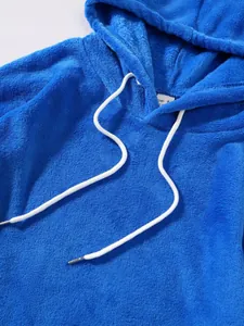 Close-up of vibrant blue plush fleece hoodie featuring soft white drawstring detail