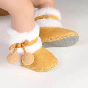 Close-up of mustard yellow baby boots with soft white fur and non-slip soles