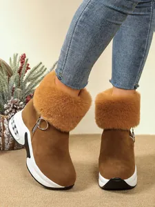Detailed view of women's brown snow boots with plush faux fur trim and platform sole