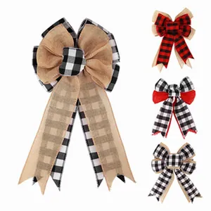 Detailed view of large rustic Christmas bows featuring buffalo plaid and burlap textures