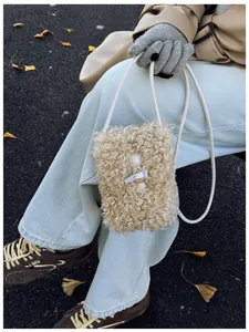 Cozy beige faux fur mobile phone bag shown in a stylish outdoor autumn setting