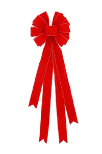 Detailed view of a large red velvet Christmas bow with shimmering gold wire edges.